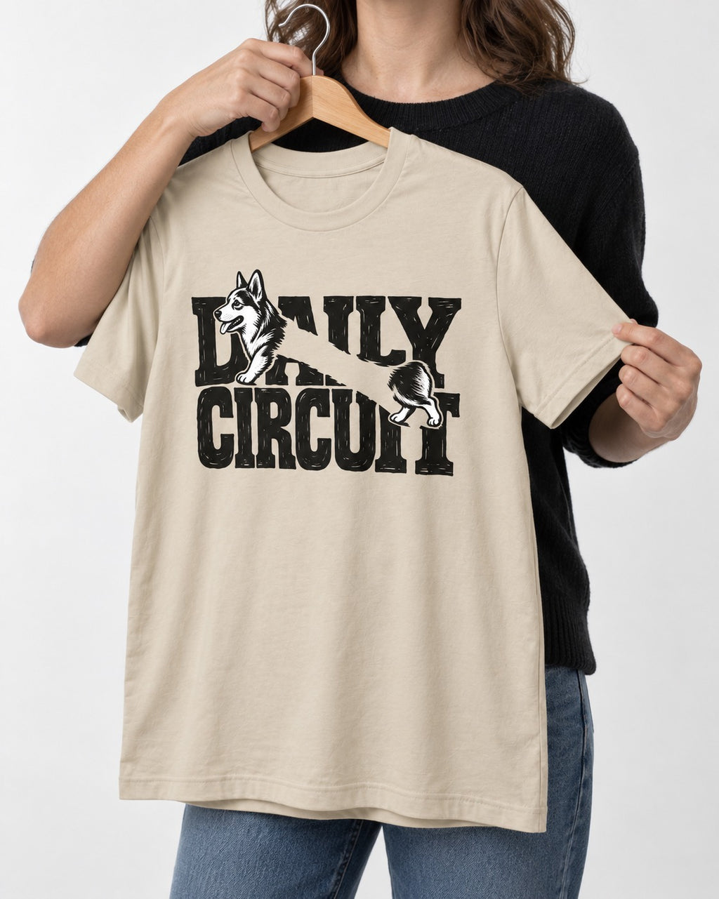 Daily Corgi Circuit T-Shirt in Sand, held up on a hanger