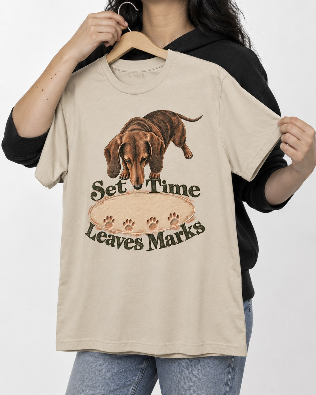 Dachshund Time Leaves Marks T-Shirt in Sand, held up on a hanger