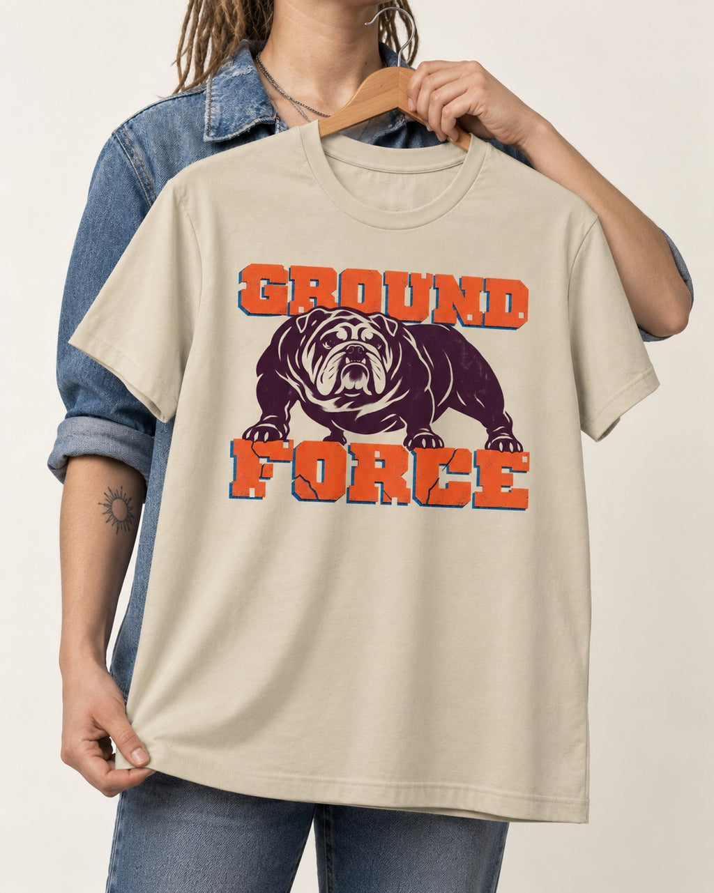 Ground Force English Bulldog T-Shirt in Sand, held up on a hanger