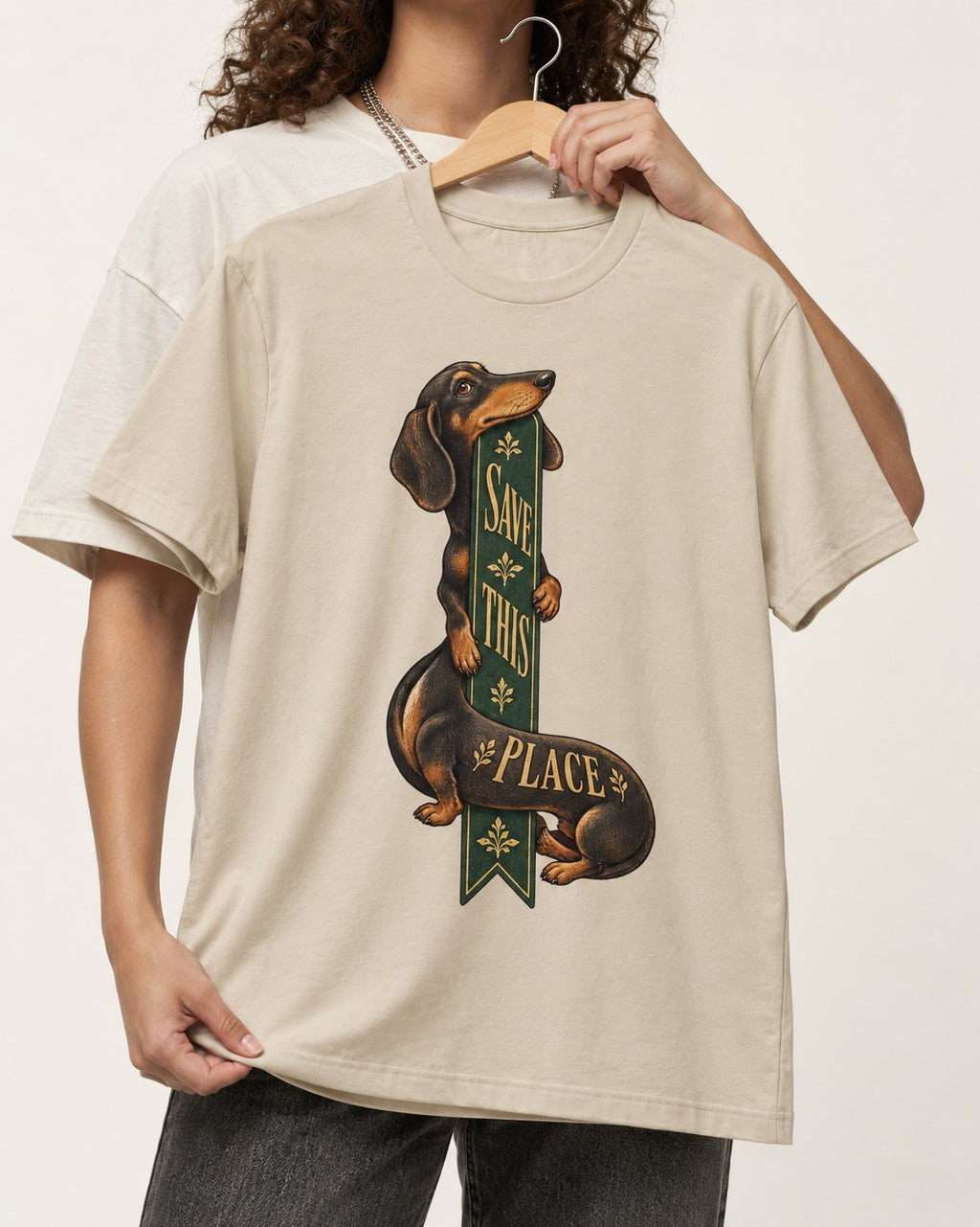 Save This Place Dachshund T-Shirt in Sand, held up on a hanger