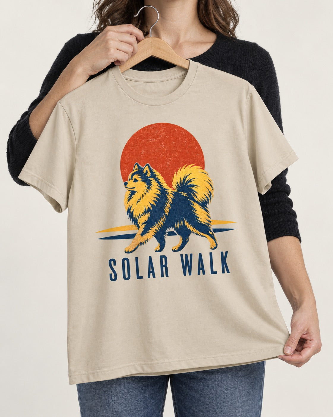 Pomeranian Solar Walk T-Shirt in Sand, held up on a hanger