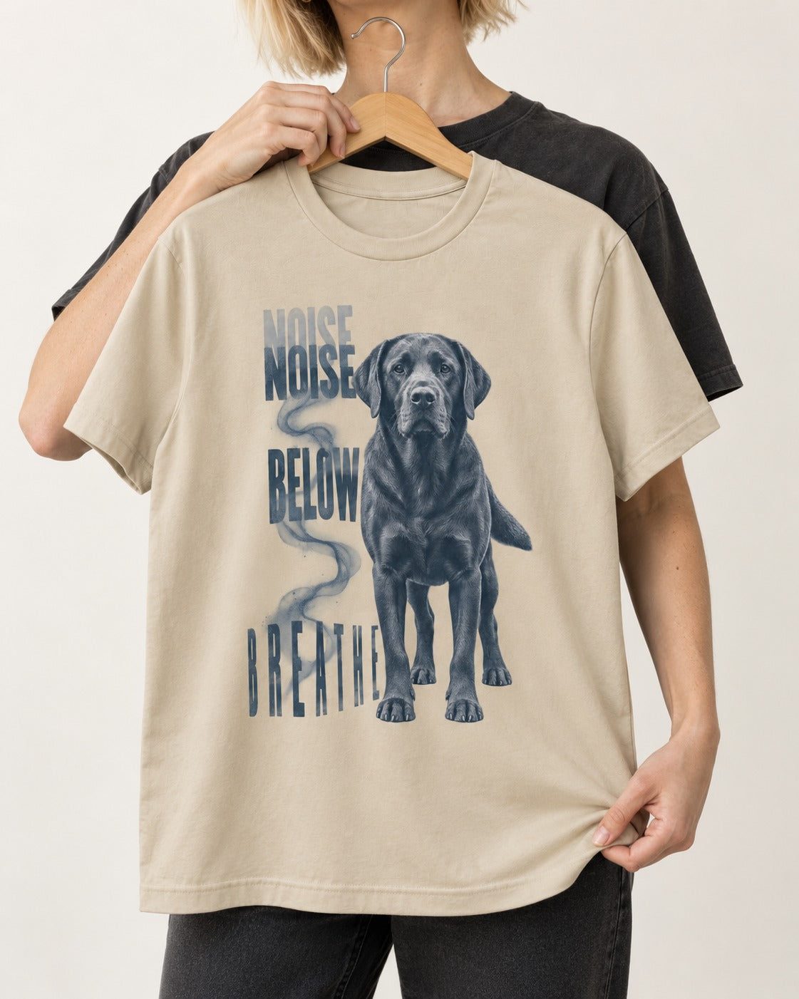 Labrador Retriever Breathe Below the Noise T-Shirt in Sand, held up on a hanger