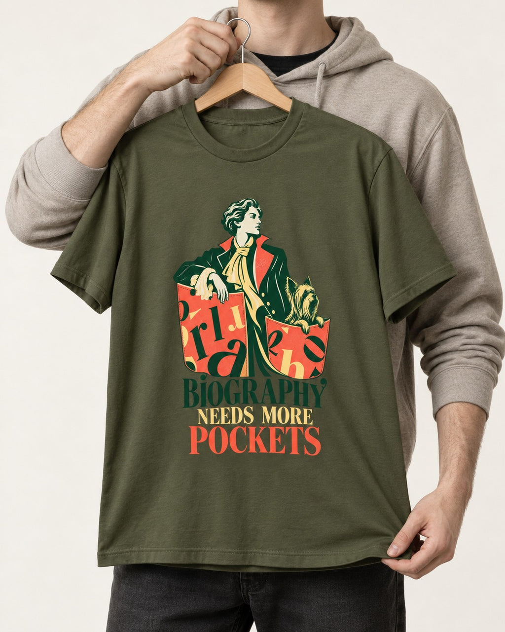 Yorkshire Terrier Biography Needs More Pockets Literary Portrait Graphic T-Shirt in Heather Military Green, held up on a hanger