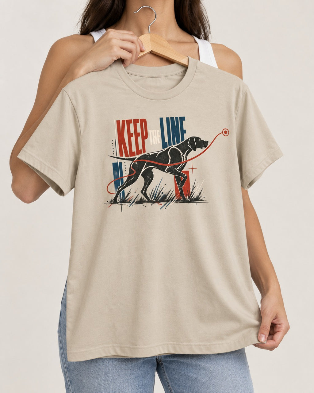 Keep the Line German Shorthaired Pointer T-Shirt in Sand, held up on a hanger