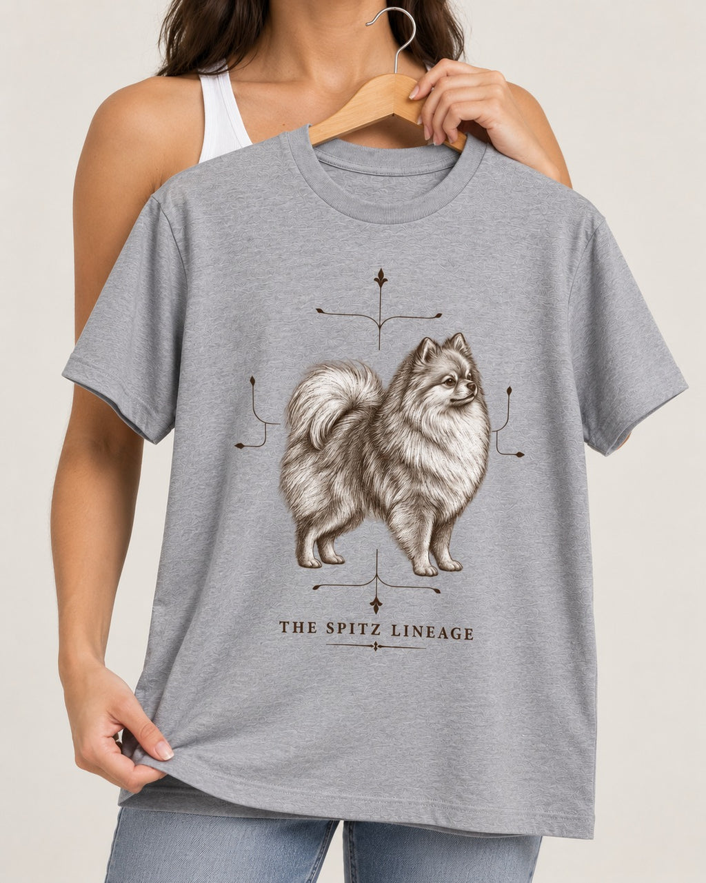 Pomeranian Spitz Lineage T-Shirt in Sport Grey, held up on a hanger