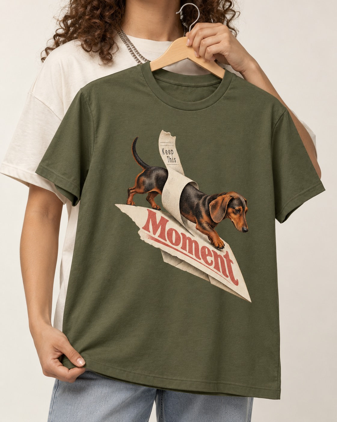 Dachshund Keep This Moment Receipt Graphic T-Shirt in Heather Military Green, held up on a hanger