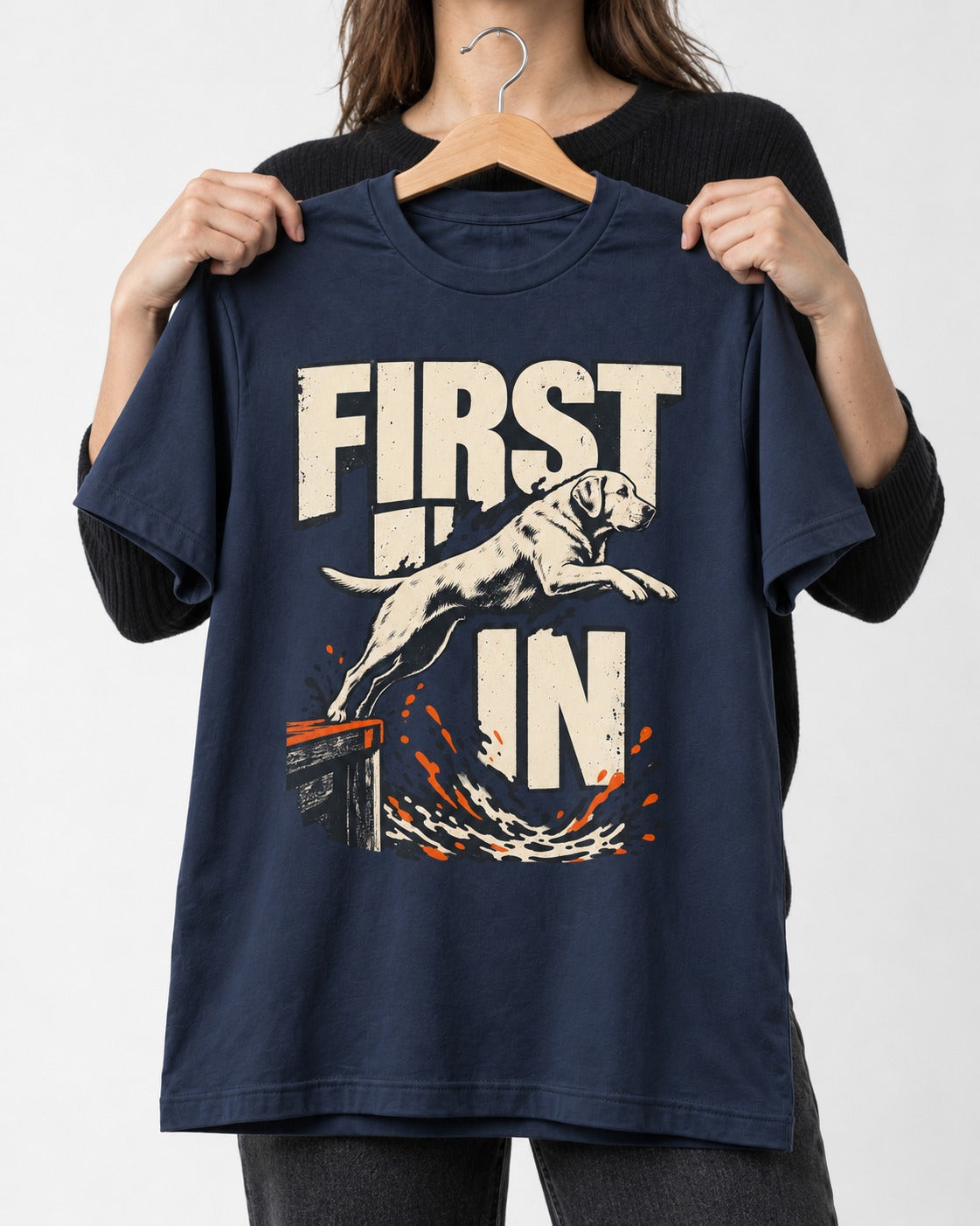 First In Dock Jump Labrador Retriever Graphic T-Shirt in Navy, held up on a hanger