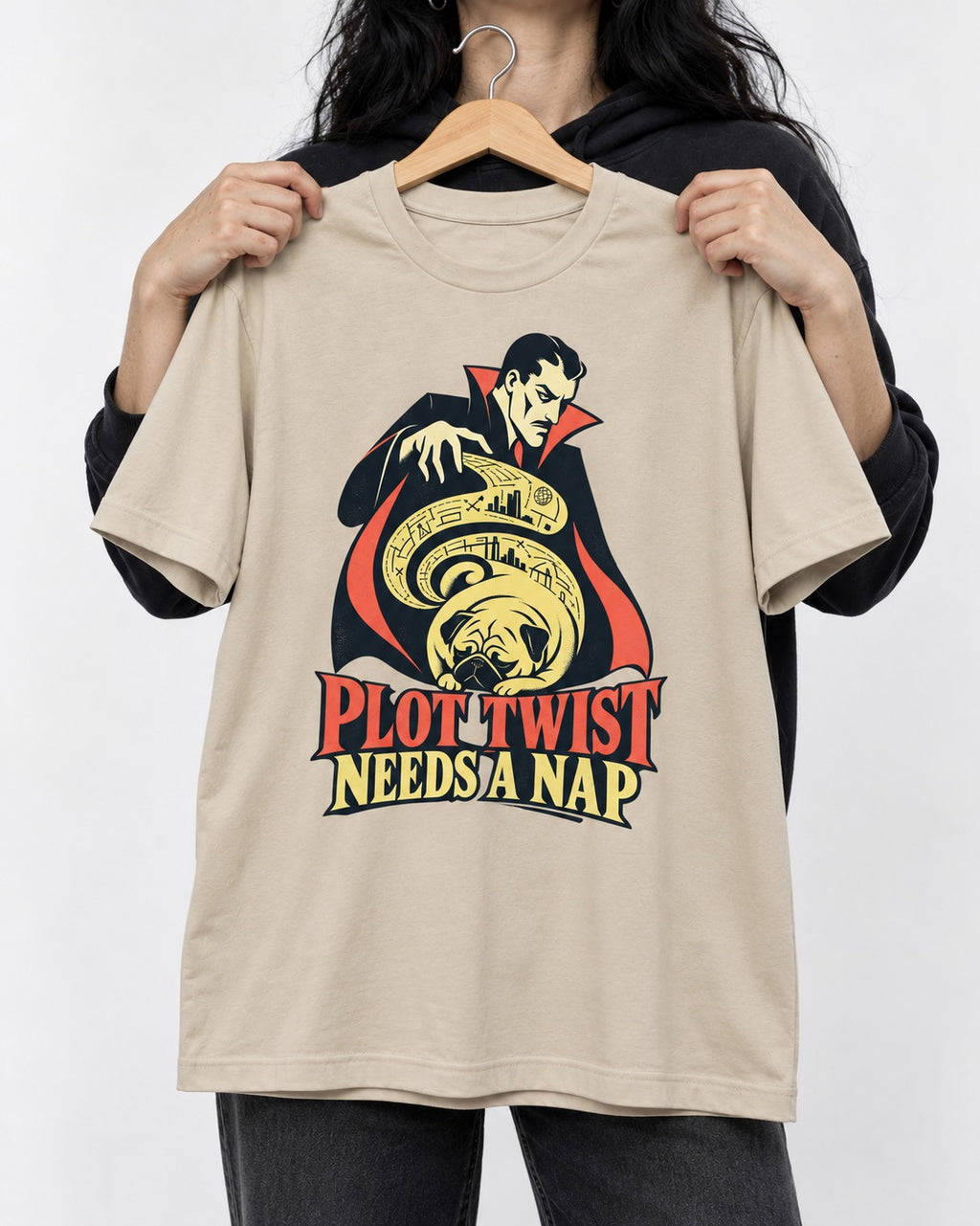 Pug Needs a Nap T-Shirt in Sand, held up on a hanger