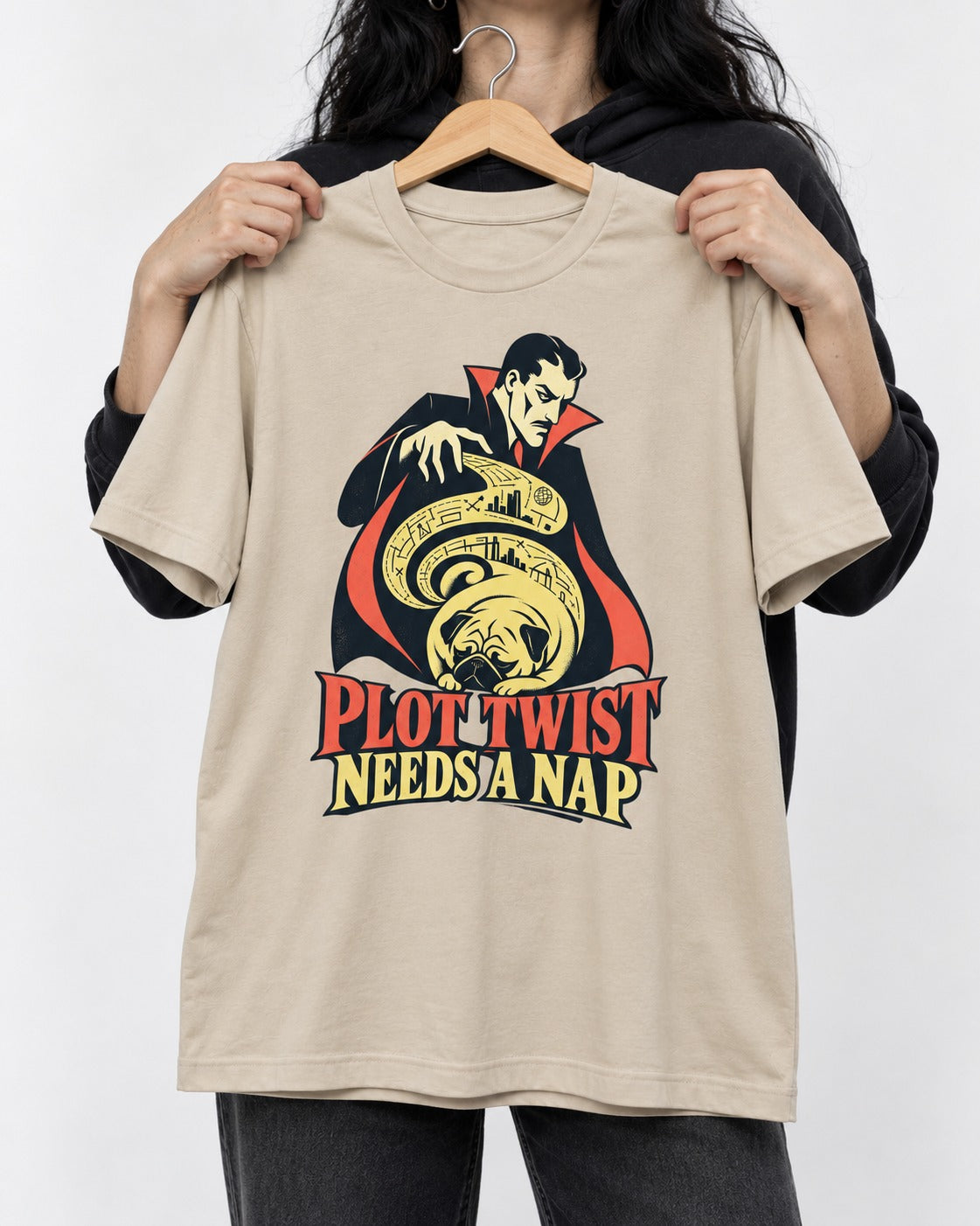 Pug Needs a Nap T-Shirt in Sand, held up on a hanger