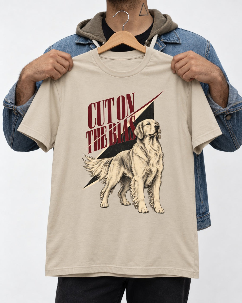 Cut on the Bias Golden Retriever T-Shirt in Sand, held up on a hanger