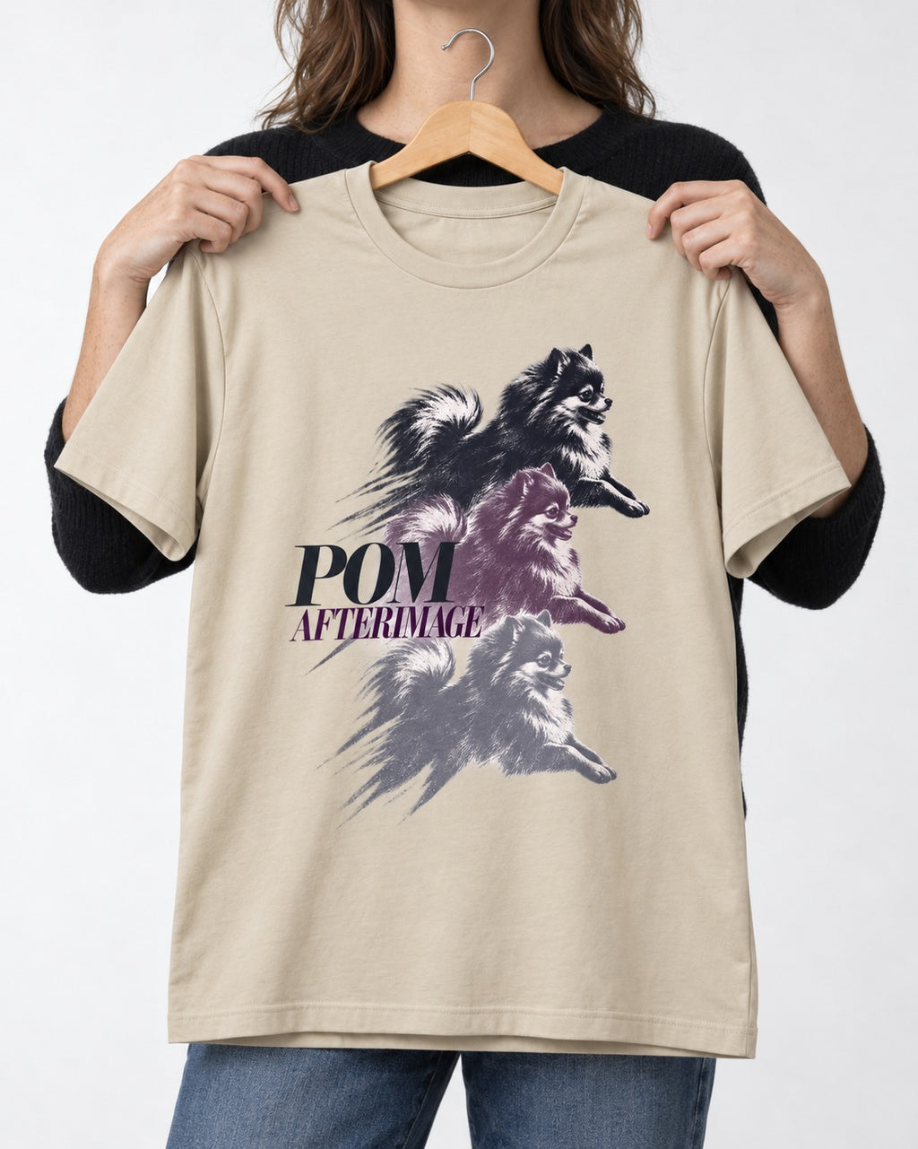 Pomeranian Afterimage T-Shirt in Sand, held up on a hanger