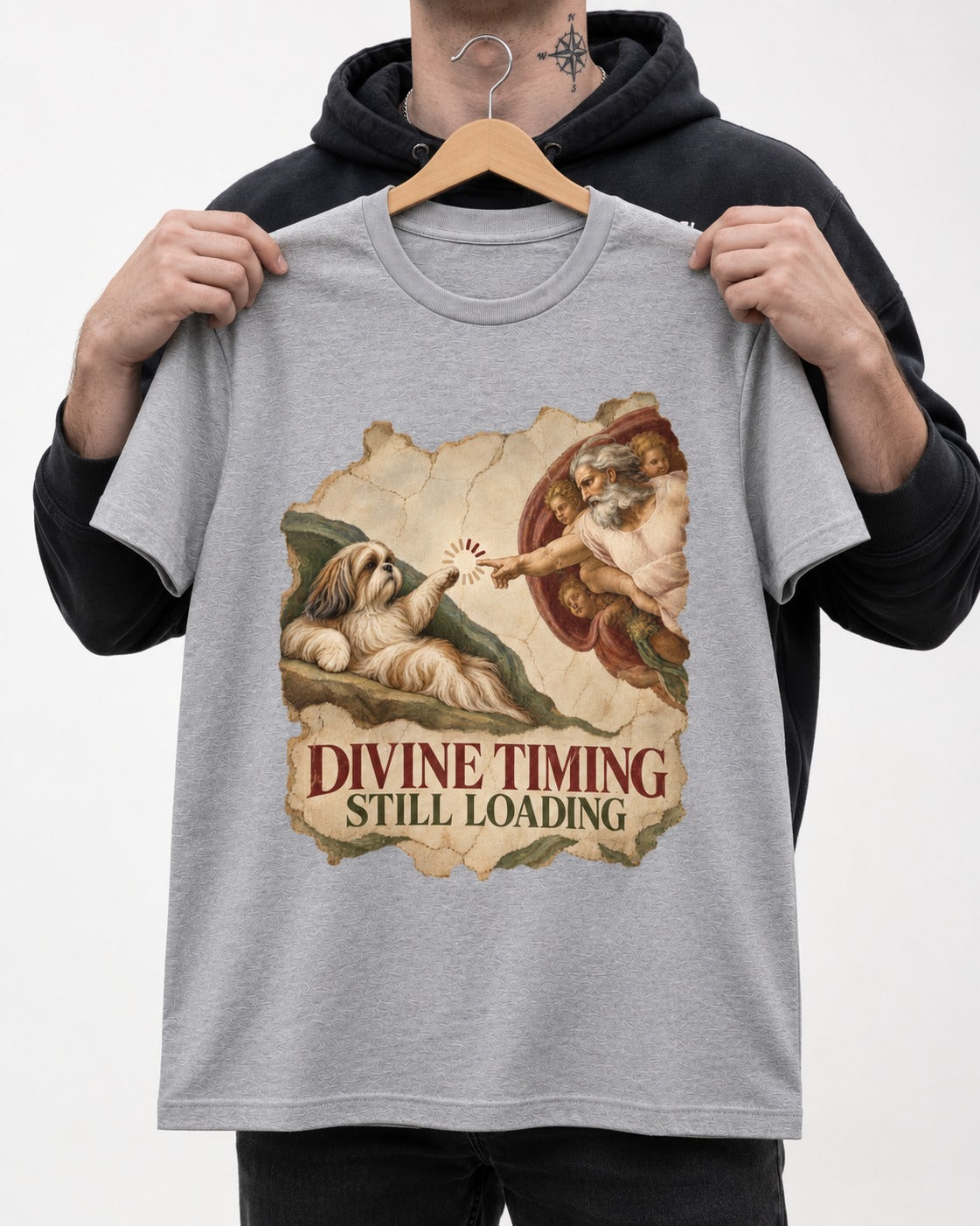 Shih Tzu Divine Timing Still Loading Renaissance Parody Graphic T-Shirt in Sport Grey, held up on a hanger