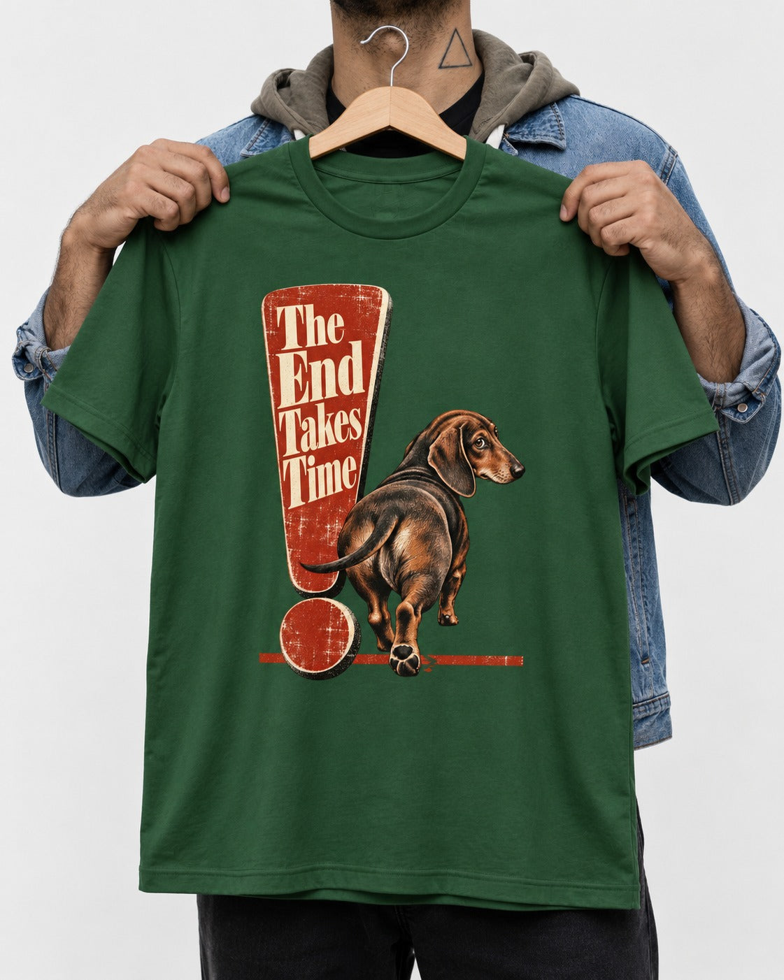 Dachshund The End Takes Time Exclamation Mark Graphic T-Shirt in Forest Green, held up on a hanger
