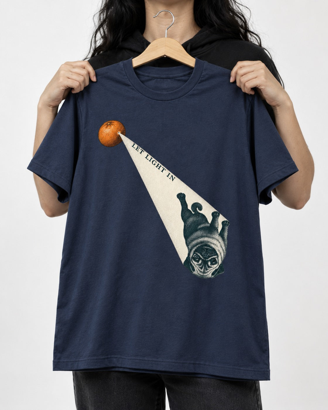 Pug Let Light In Camera Obscura Graphic T-Shirt in Navy, held up on a hanger