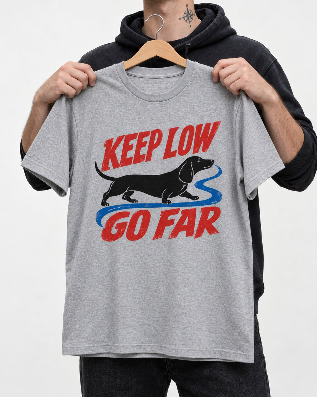 Keep Low Go Far Dachshund T-Shirt in Sport Grey, held up on a hanger