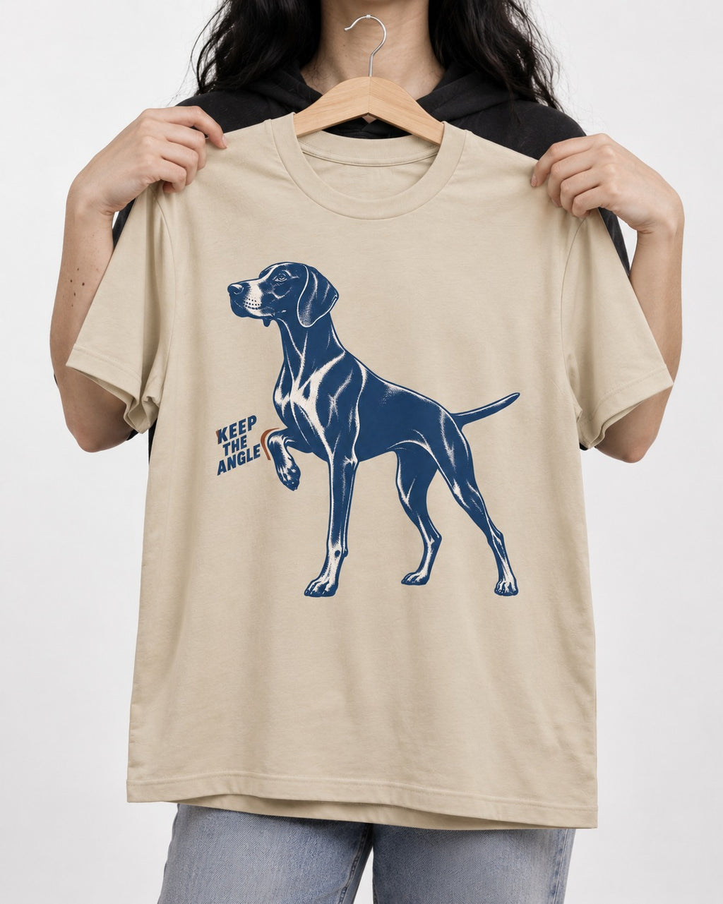 Keep the Angle German Shorthaired Pointer T-Shirt in Sand, held up on a hanger