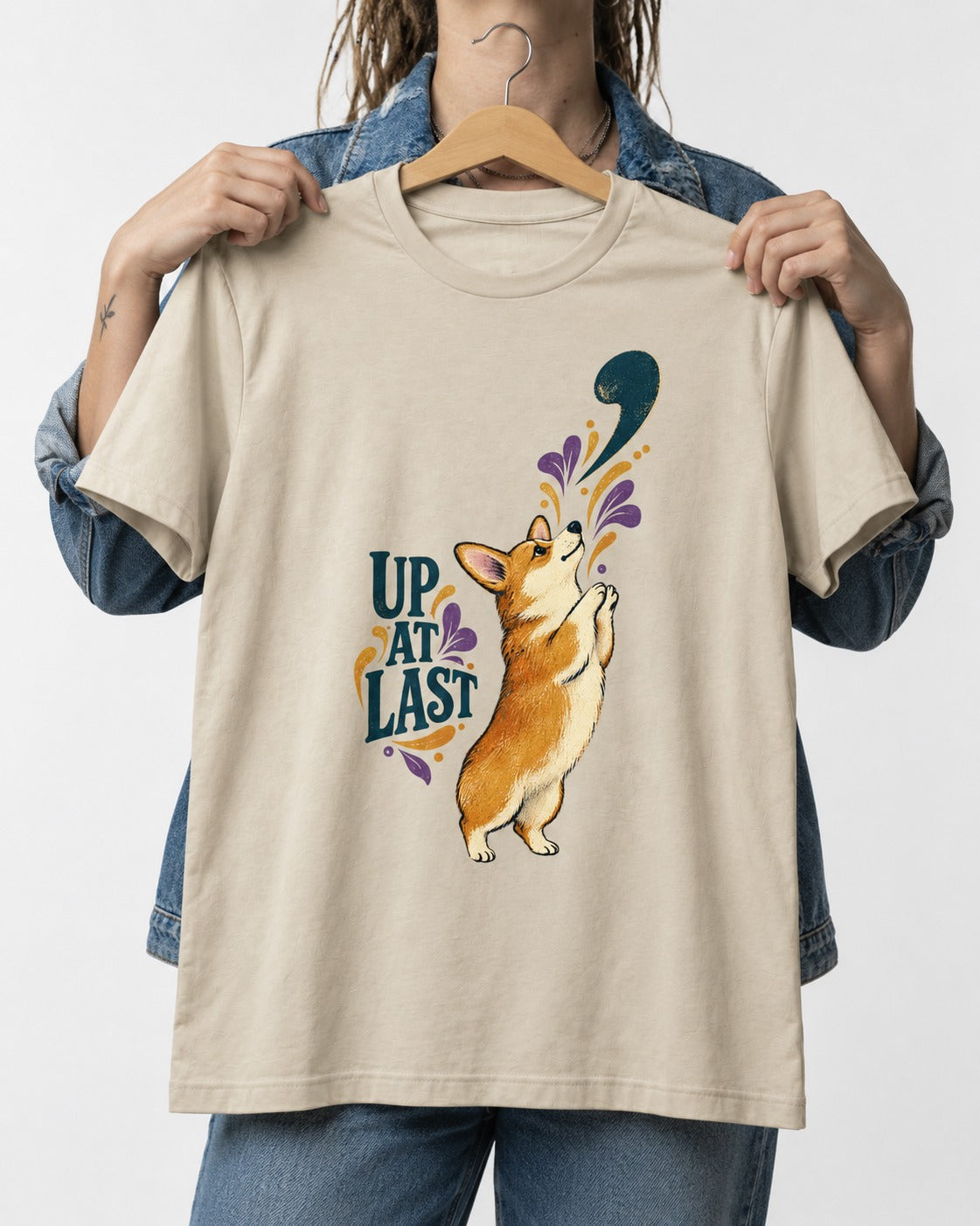 Corgi Up at Last T-Shirt in Sand, held up on a hanger