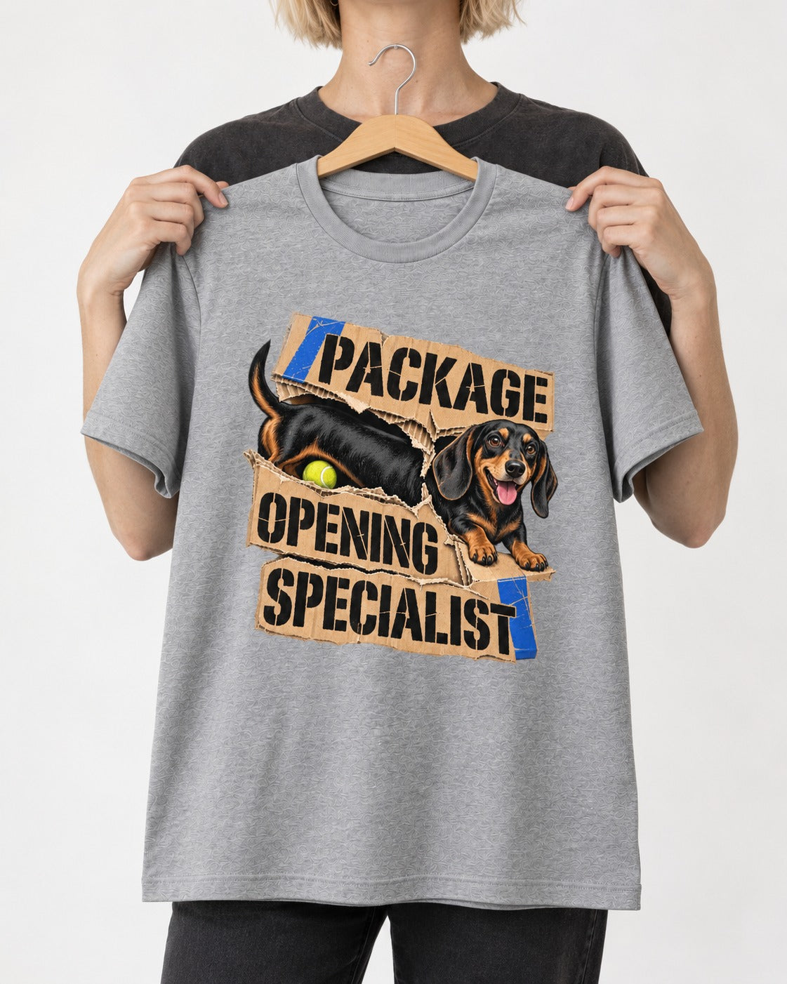 Dachshund Package Opening Specialist T-Shirt in Sport Grey, held up on a hanger