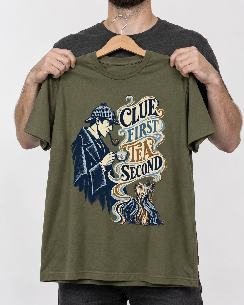 Yorkshire Terrier Clue First Tea Second Detective Graphic T-Shirt in Heather Military Green, held up on a hanger