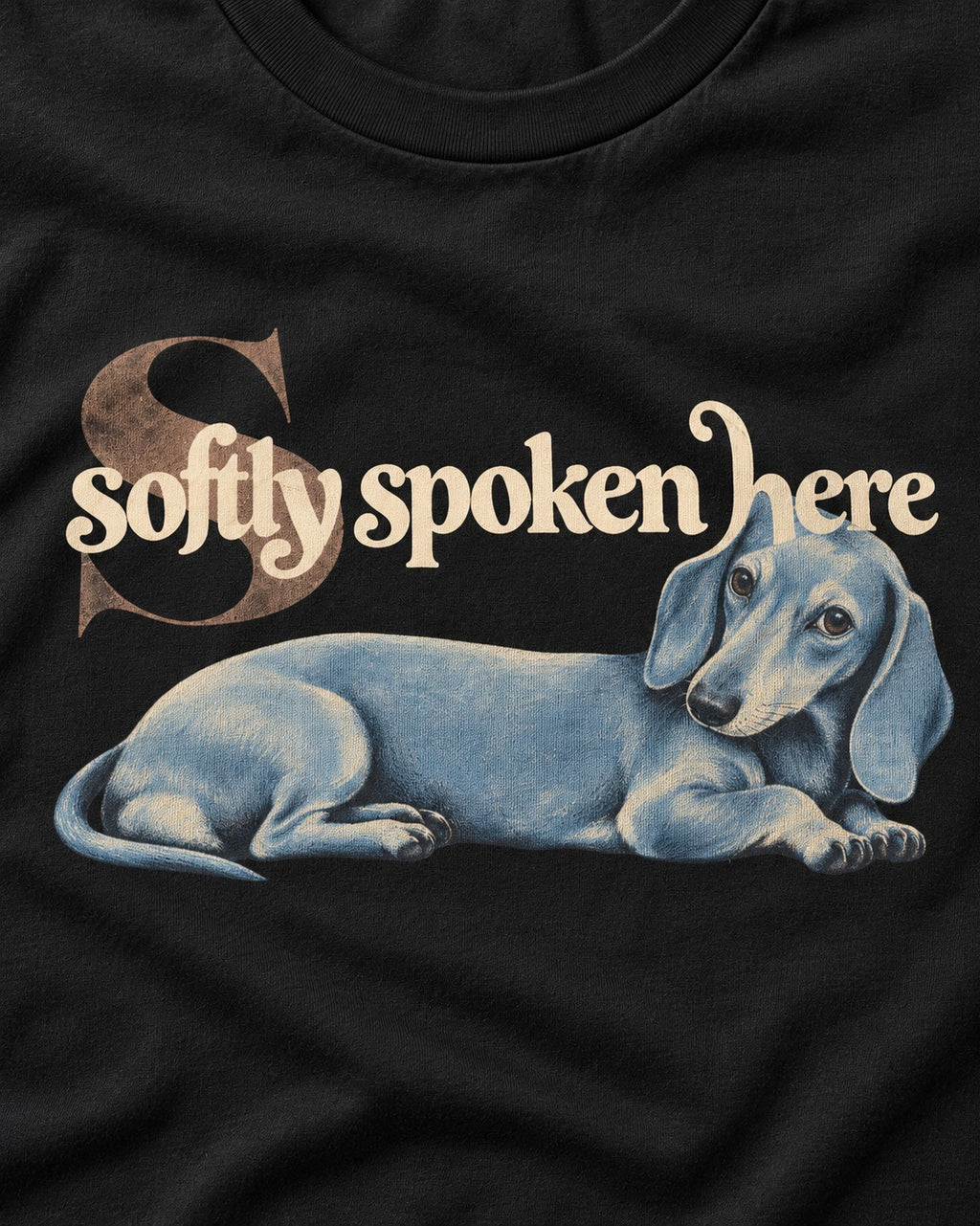 Dachshund Softly Spoken Here Reclining Portrait Graphic T-Shirt in Black, close-up of the graphic