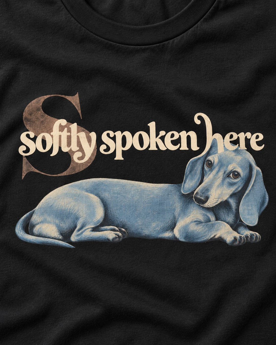 Dachshund Softly Spoken Here Reclining Portrait Graphic T-Shirt in Black, close-up of the graphic