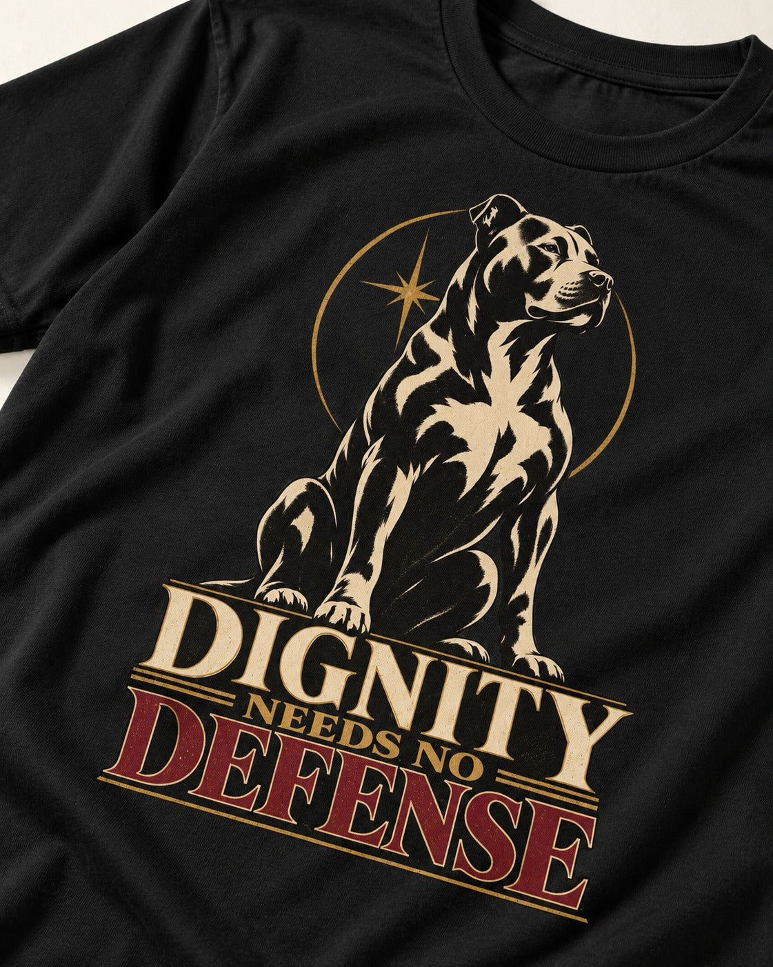 Pitbull Dignity Needs No Defense Seated Emblem Graphic T-Shirt in Black, close-up of the graphic