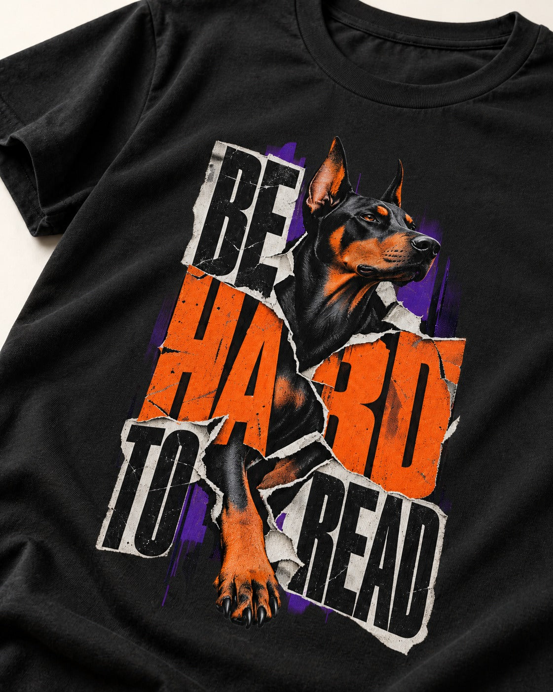 Doberman Be Hard to Read Torn Poster Graphic T-Shirt in Black, close-up of the graphic