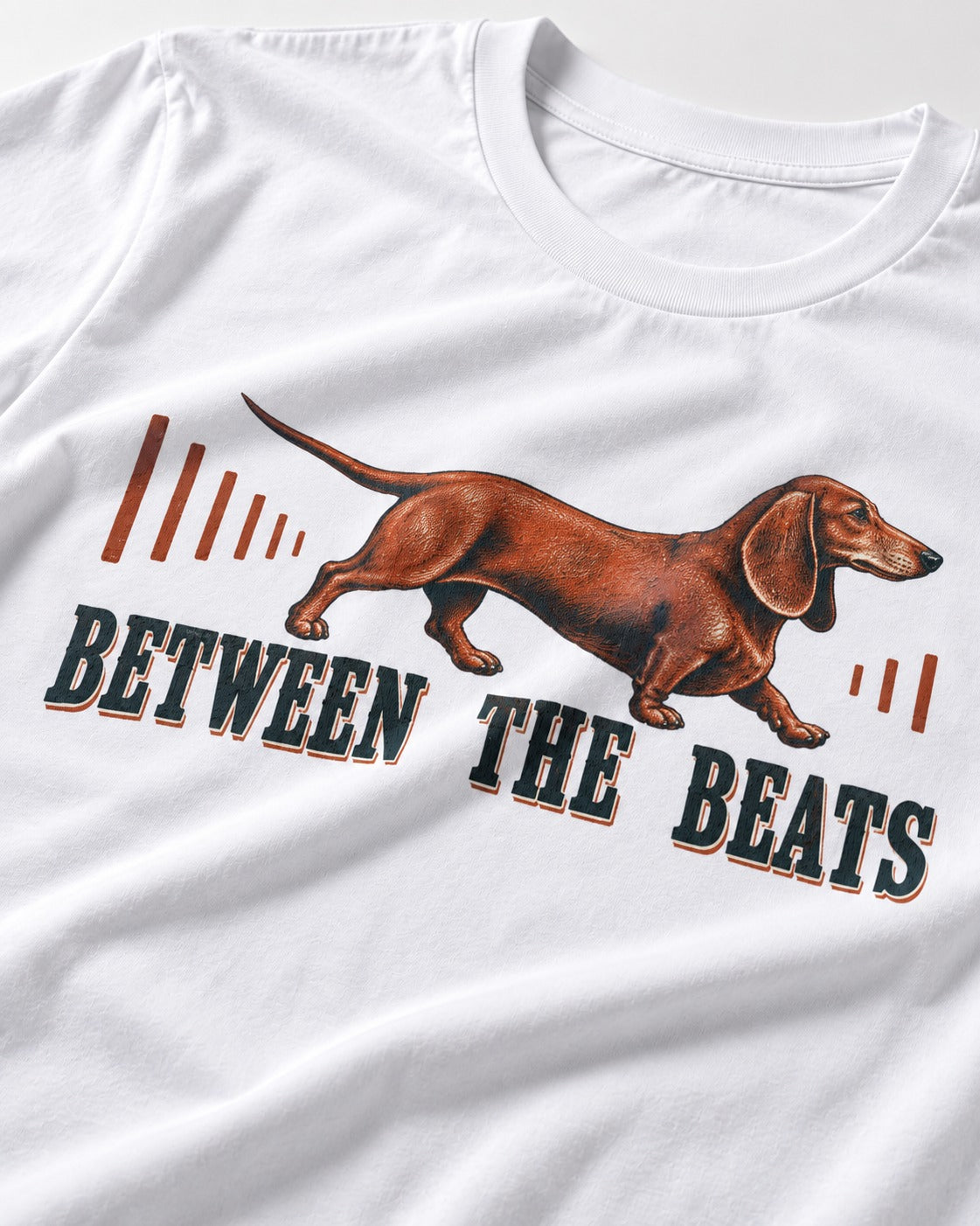 Dachshund Between the Beats T-Shirt in White, close-up of the graphic