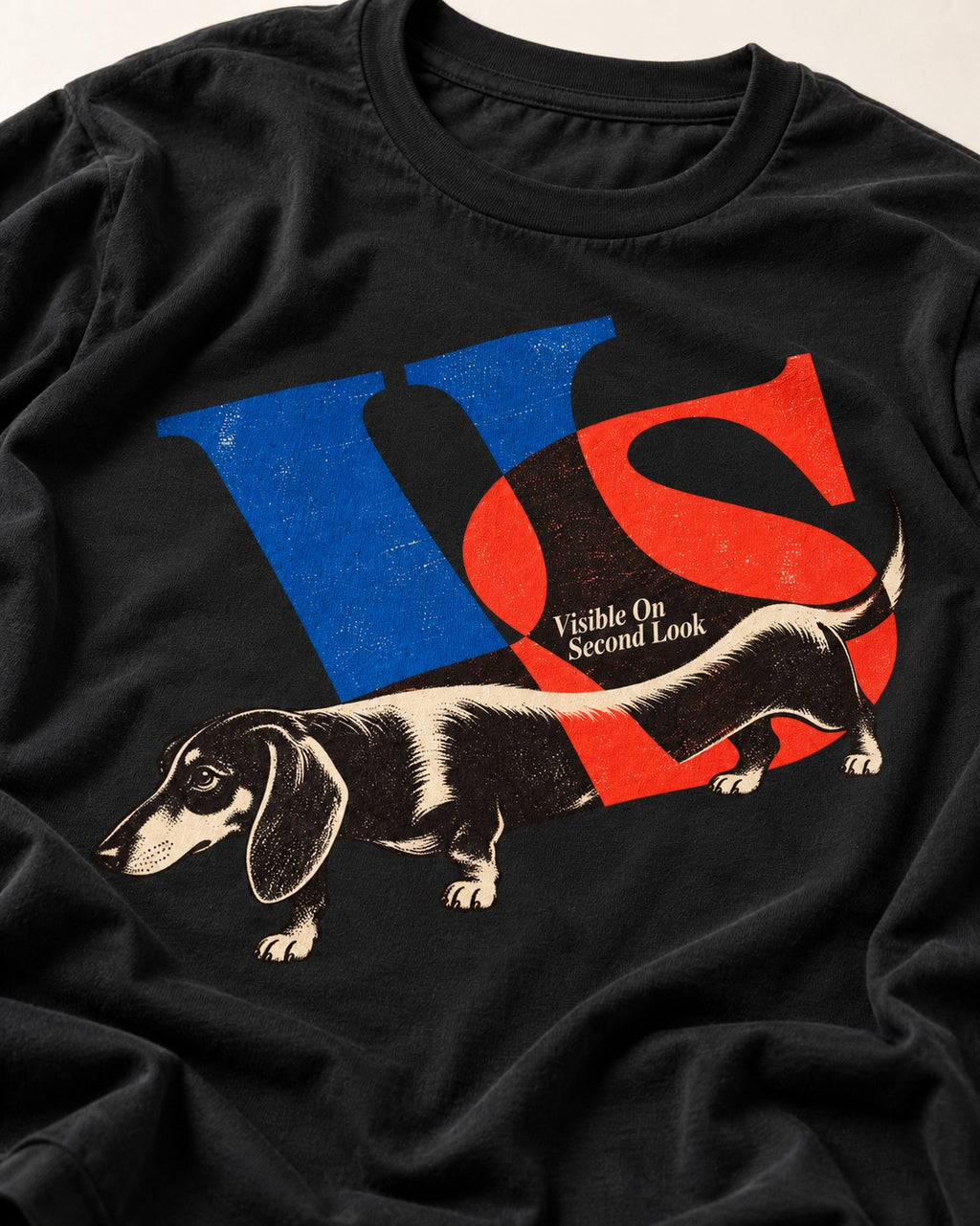 Dachshund VS Visible On Second Look Graphic T-Shirt in Black, close-up of the graphic