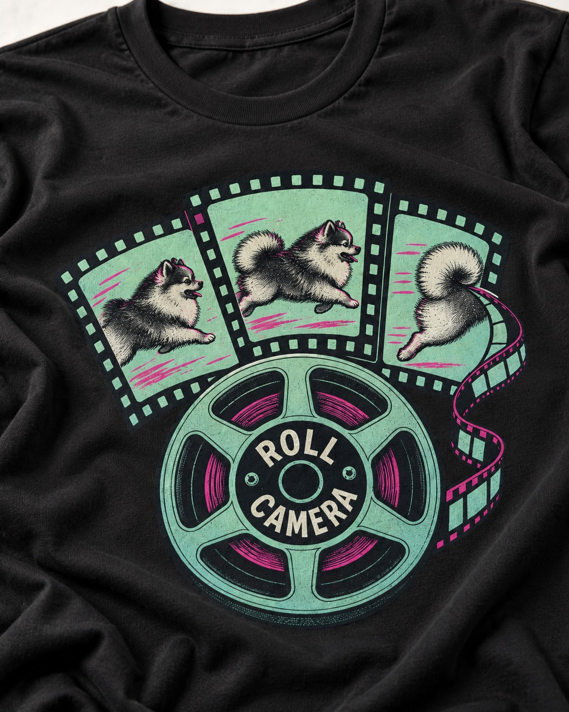 Pomeranian Roll Camera Film Reel Graphic T-Shirt in Black, close-up of the graphic