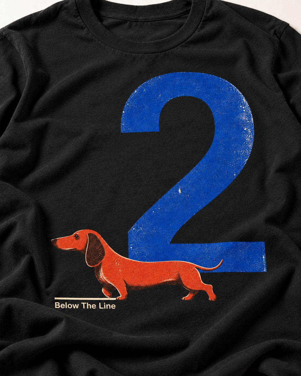 Dachshund Below The Line Number Two Graphic T-Shirt in Black, close-up of the graphic