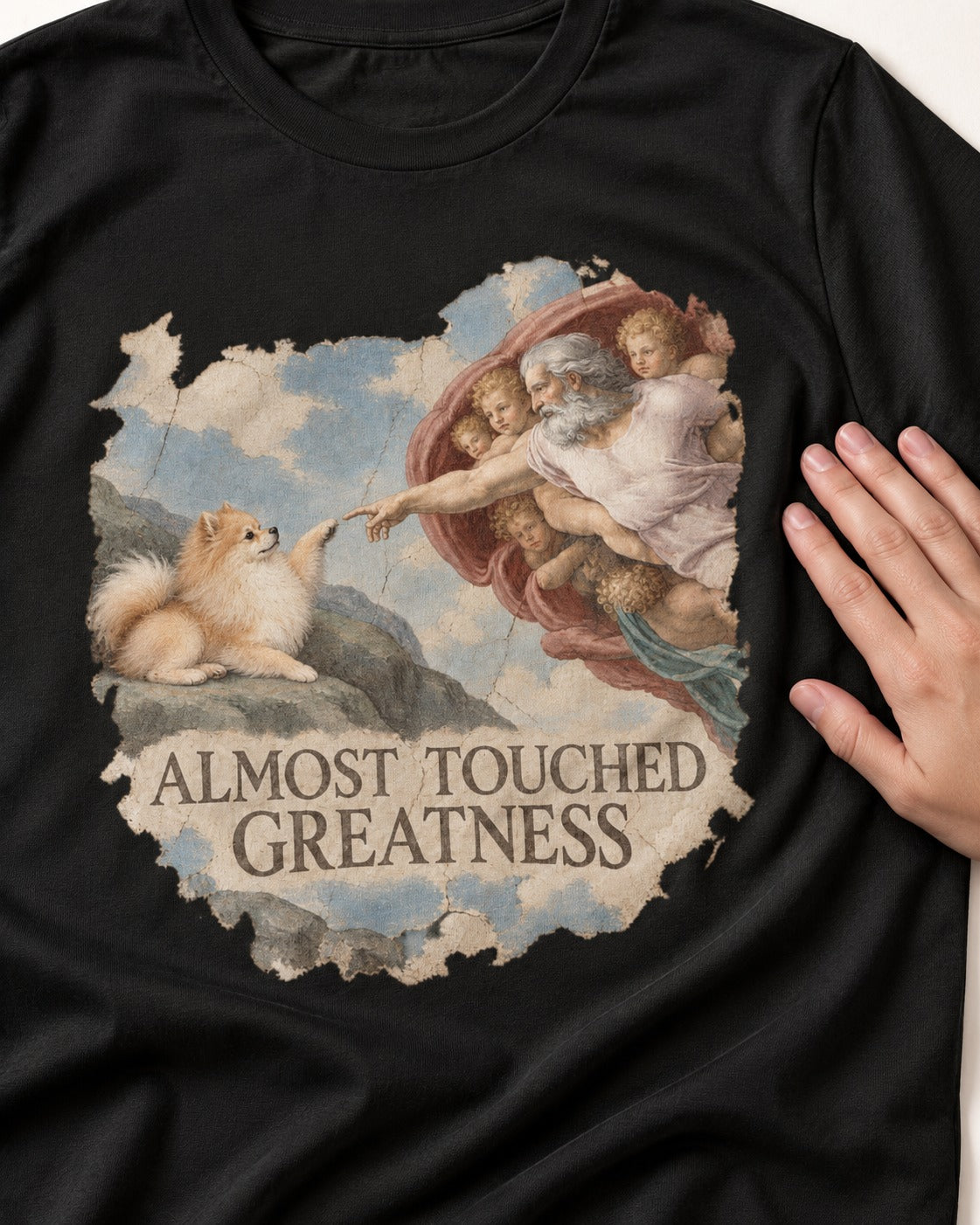 Pomeranian Almost Touched Greatness Fresco Graphic T-Shirt in Black, close-up of the graphic