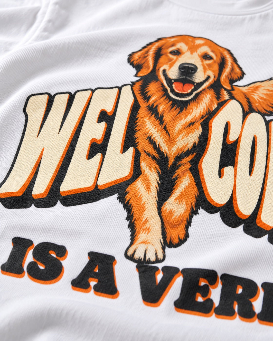 Golden Retriever Welcome Is a Verb T-Shirt in White, close-up of the graphic