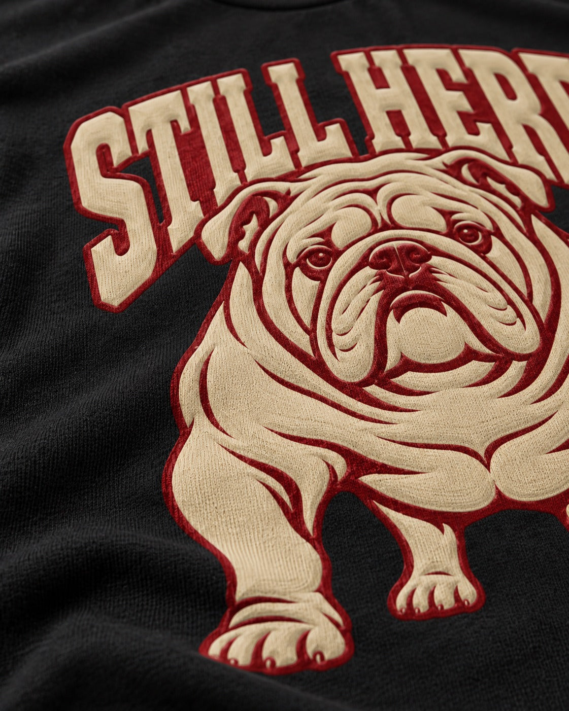 English Bulldog Still Here Collegiate Graphic T-Shirt in Black, close-up of the graphic