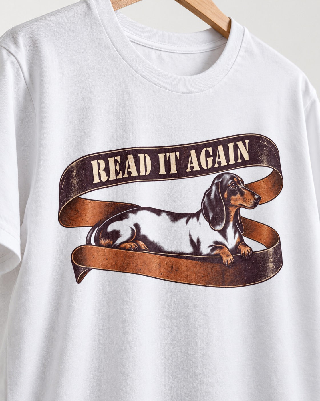 Read It Again Dachshund T-Shirt in White, close-up of the graphic