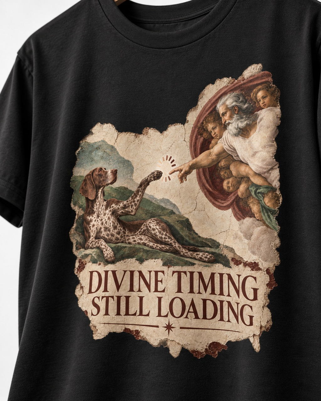 German Shorthaired Pointer Divine Timing Still Loading Creation Scene Graphic T-Shirt in Black, close-up of the graphic