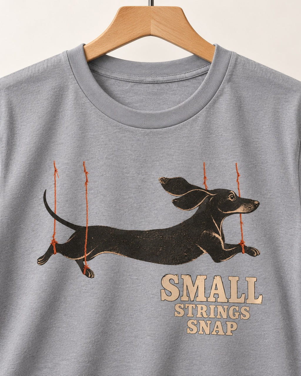 Dachshund Small Strings Snap Marionette Graphic T-Shirt in Sport Grey, close-up of the graphic