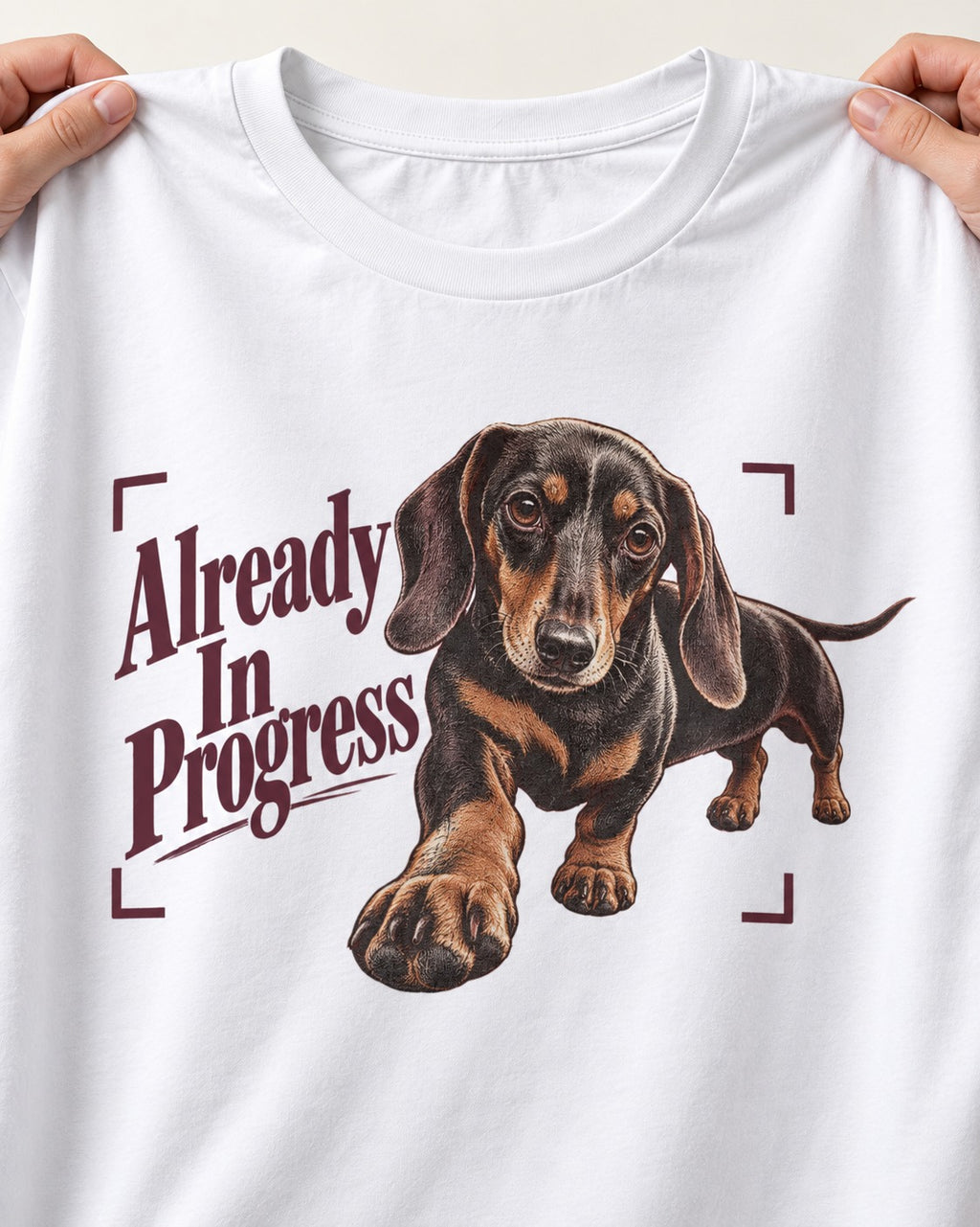 Dachshund Already in Progress T-Shirt in White, close-up of the graphic