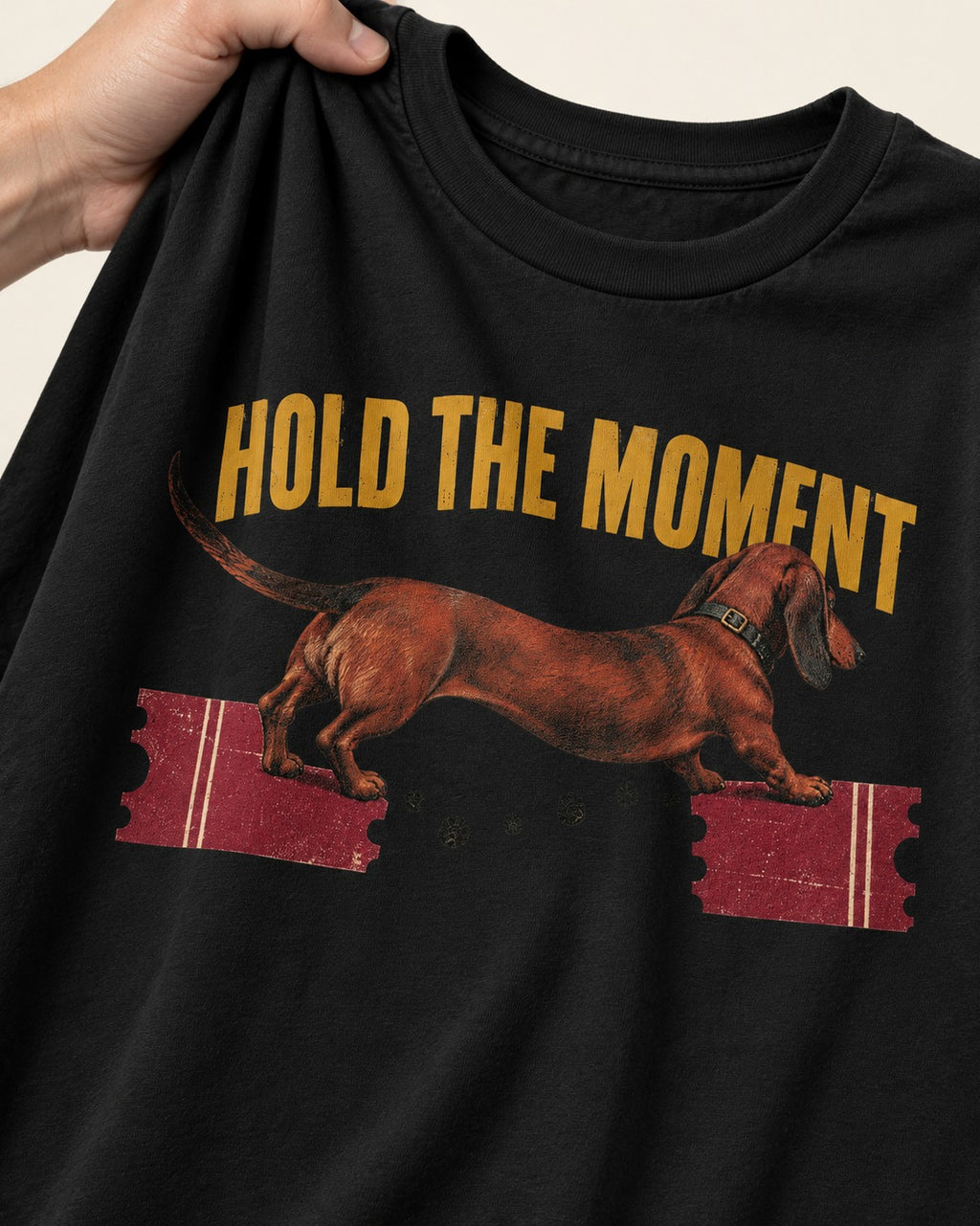 Dachshund Hold The Moment Torn Ticket Bridge Graphic T-Shirt in Black, close-up of the graphic