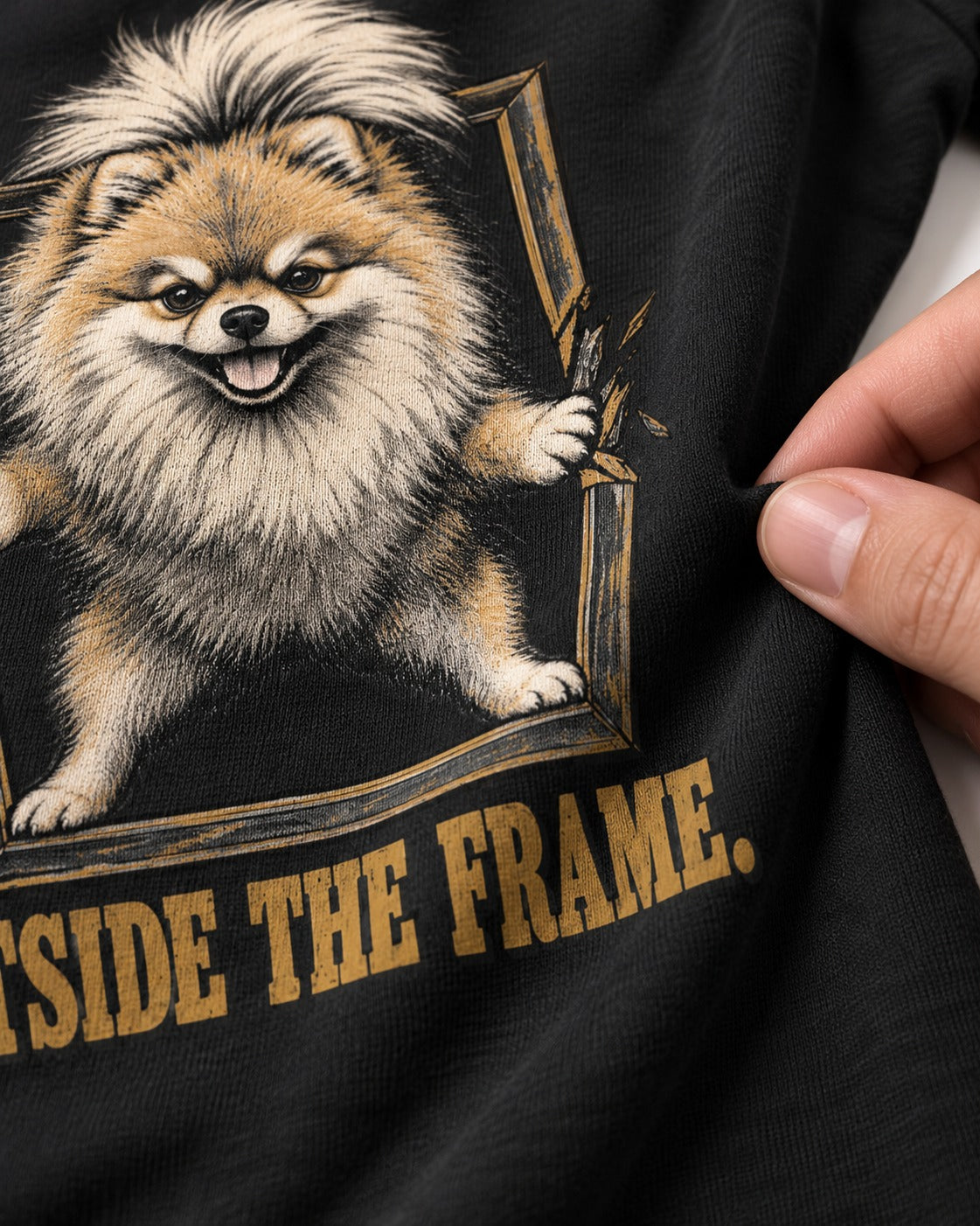 Pomeranian Outside the Frame Breakthrough Graphic T-Shirt in Black, close-up of the graphic