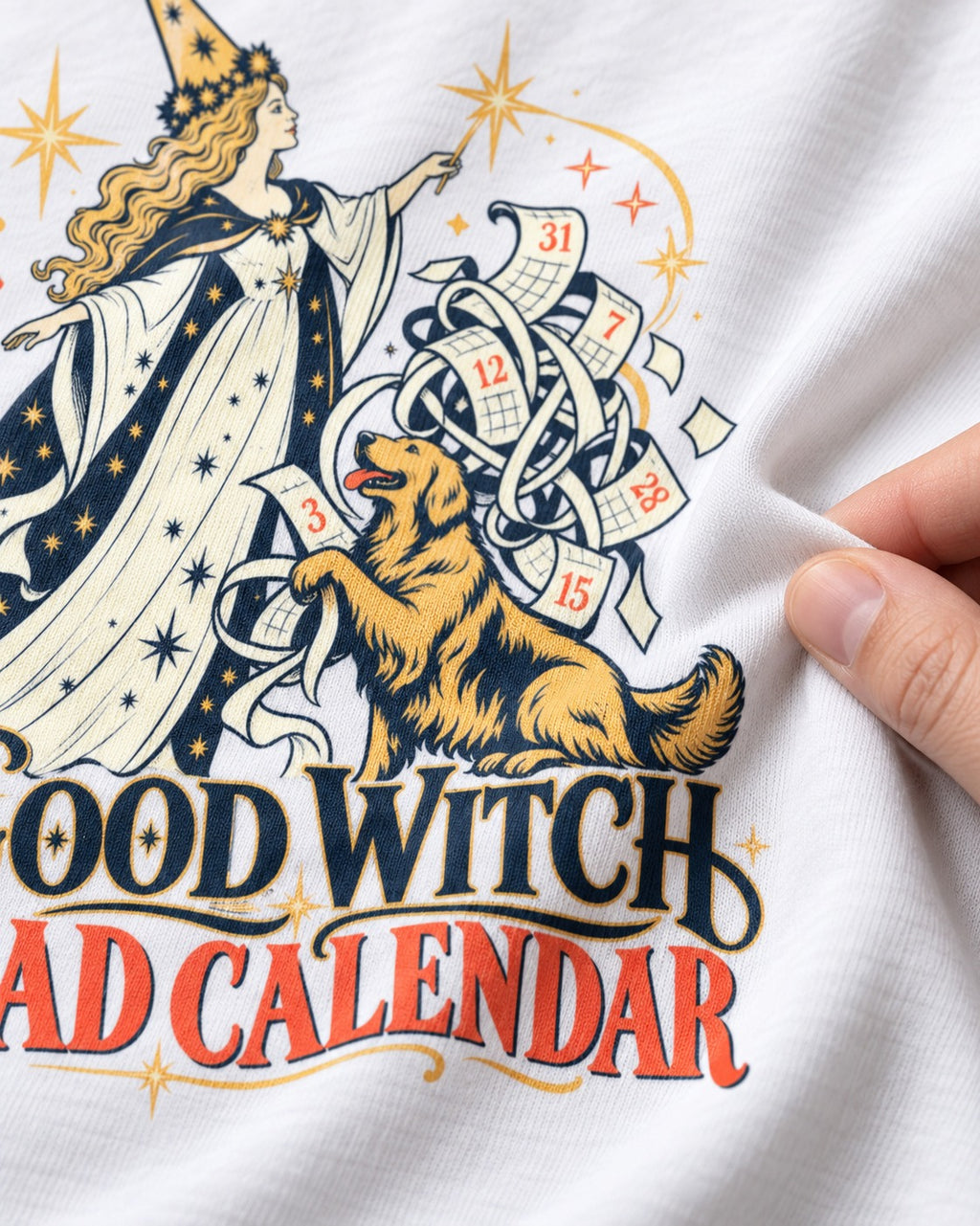 Good Witch Bad Calendar Golden Retriever T-Shirt in White, close-up of the graphic
