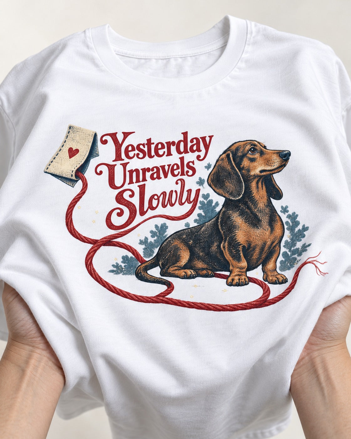 Yesterday Unravels Slowly with Dachshund T-Shirt in White, close-up of the graphic