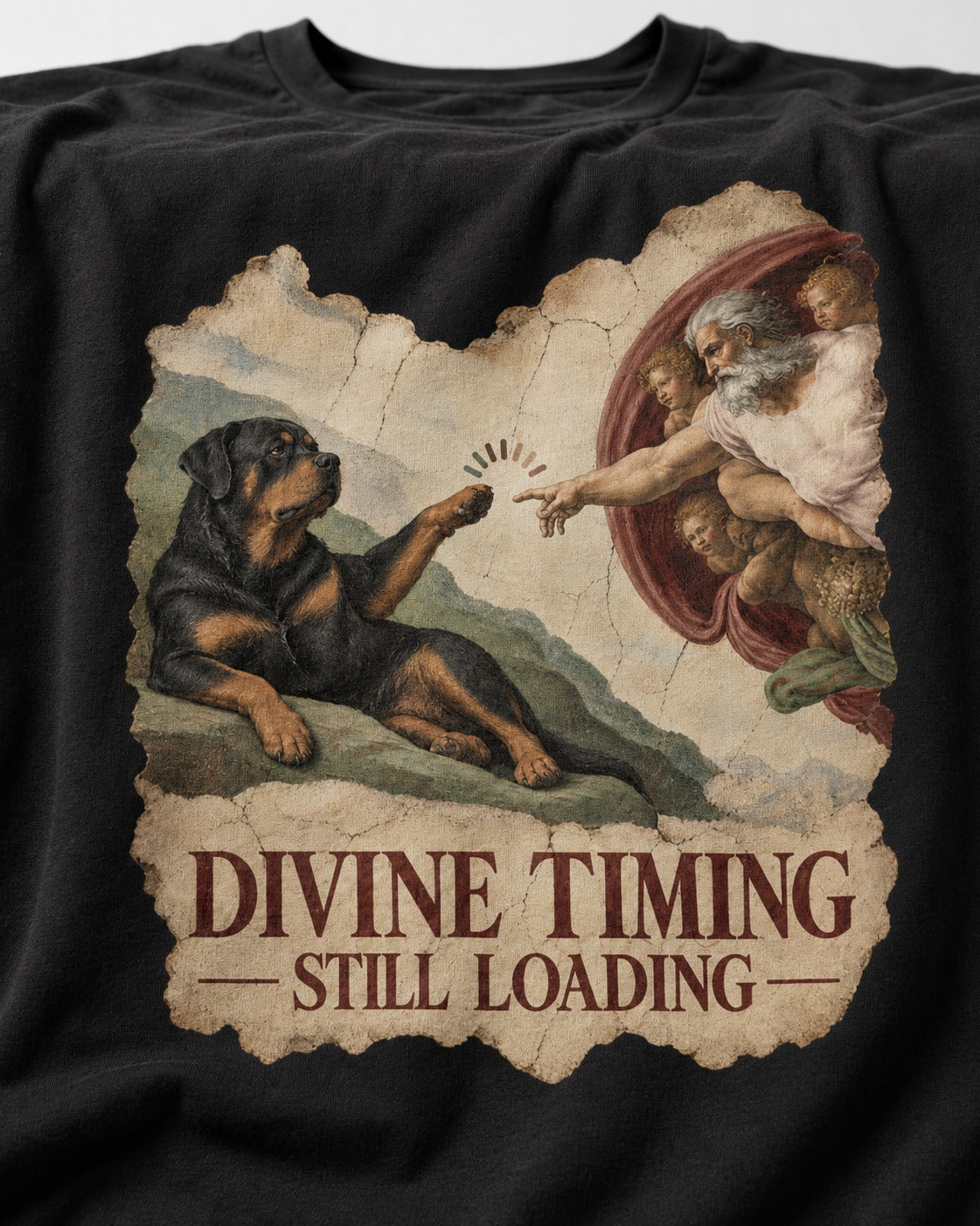 Rottweiler Divine Timing Still Loading Creation Parody Graphic T-Shirt in Black, close-up of the graphic