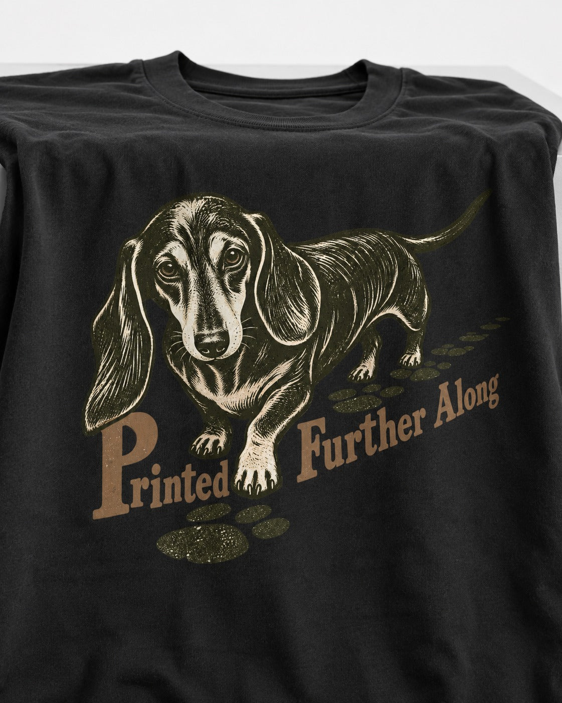 Dachshund Printed Further Along Footprint Graphic T-Shirt in Black, close-up of the graphic