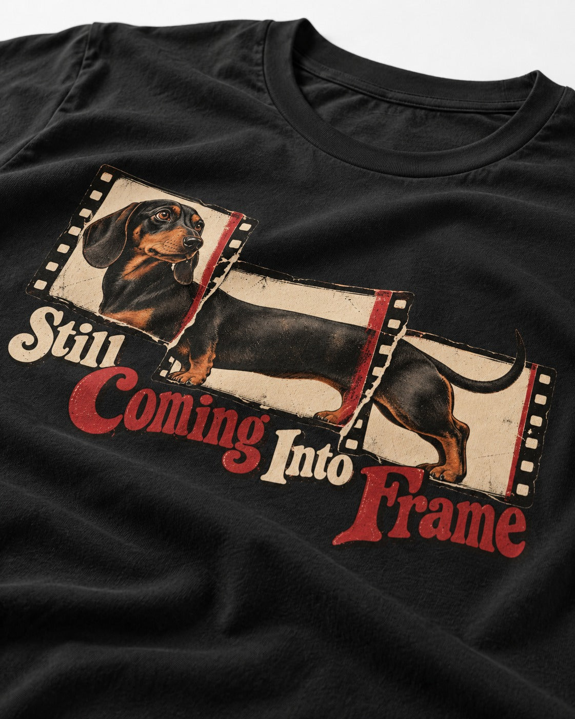 Dachshund Still Coming Into Frame Vintage Filmstrip Graphic T-Shirt in Black, close-up of the graphic