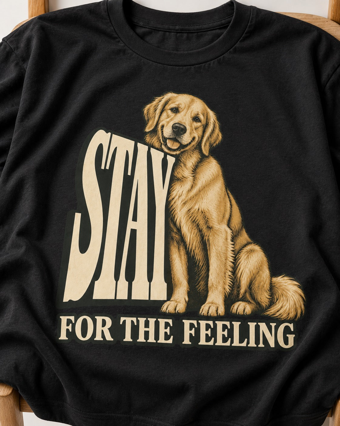 Golden Retriever Stay for the Feeling Leaning Puppy Graphic T-Shirt in Black, close-up of the graphic
