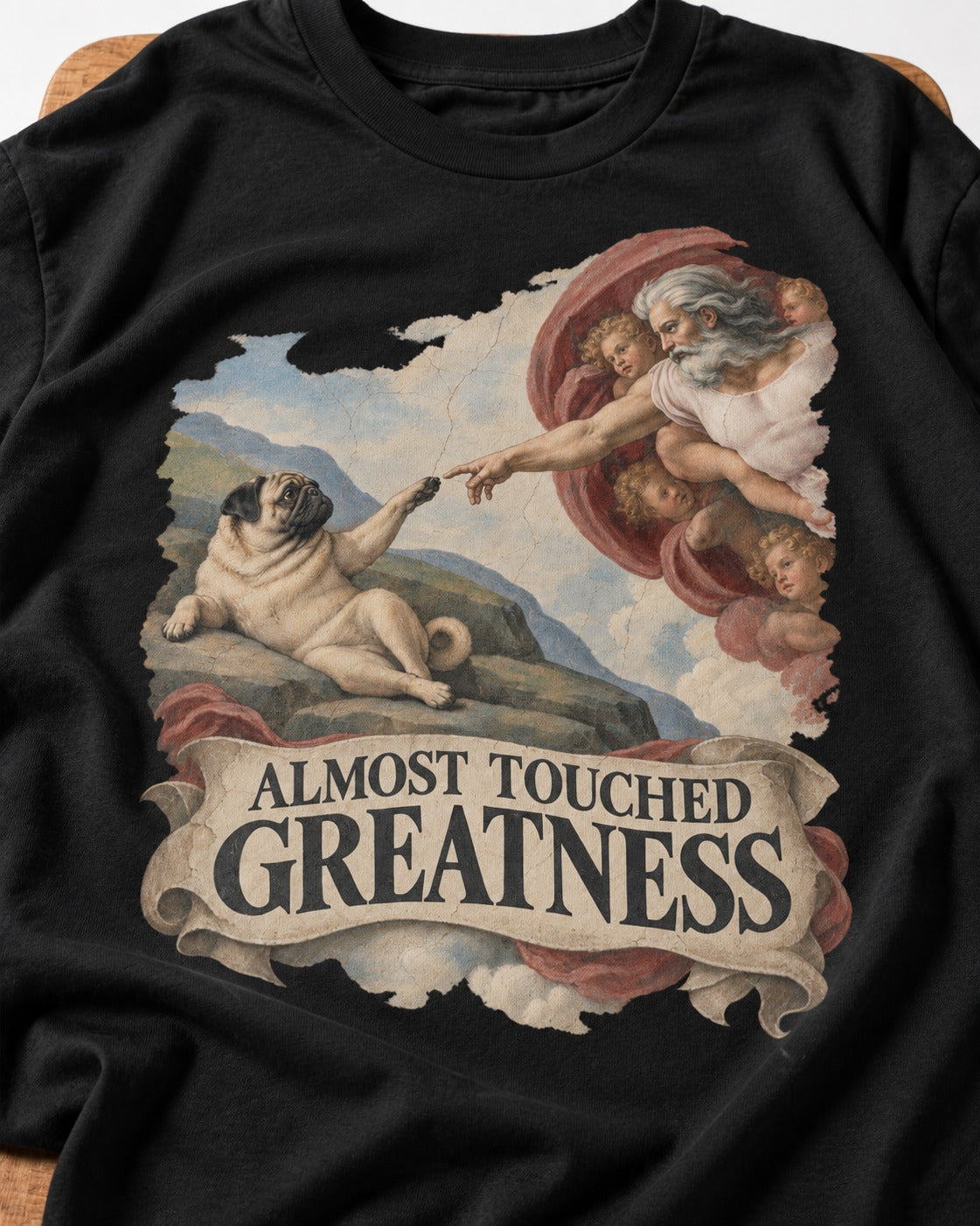 Pug Almost Touched Greatness Creation Parody Graphic T-Shirt in Black, close-up of the graphic