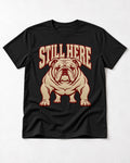 English Bulldog Still Here Collegiate Graphic T-Shirt in Black, flat lay product photo