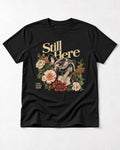 Frenchie Still Here Floral Portrait Graphic T-Shirt in Black, flat lay product photo