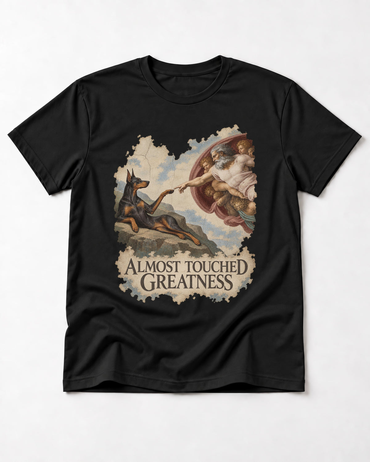 Doberman Almost Touched Greatness Creation Scene Graphic T-Shirt in Black, flat lay product photo